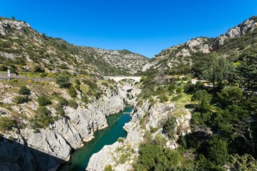 Fototapeta premium Aerial view of the Devil's Bridge over a narrow gorge of the Herault river in South France