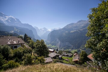 Scenic view of the Lauterbrunnen Valley in the Swiss Alps with wooden buildings surrounded by trees