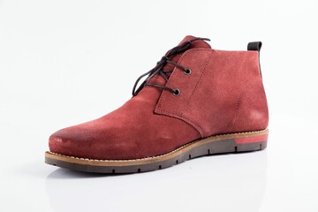 Male red leather boot on white background.