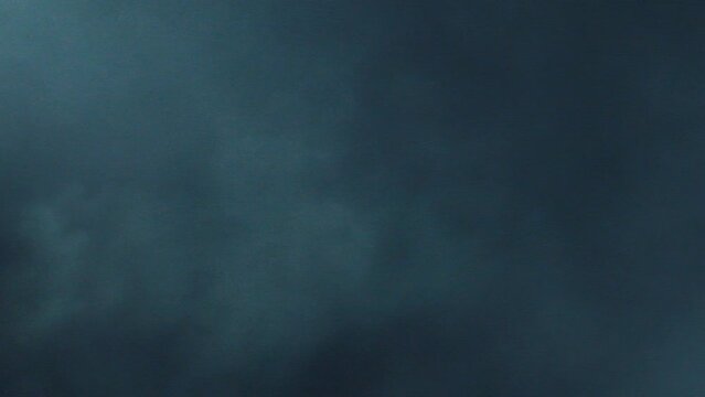 The 4K slow-motion cinematic atmosphere. Layered VFX thunder strobe light clip 4K high fps atmosphere clip with moving flickering strobe shafts of light. Inside a heavy thundercloud. Smoke machine.