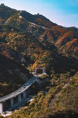 a view of a bridge with some hills behind it in the background