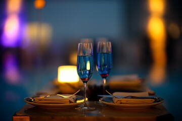 Fototapeta na wymiar Closeup shot of champagne flutes with a blue beverage.