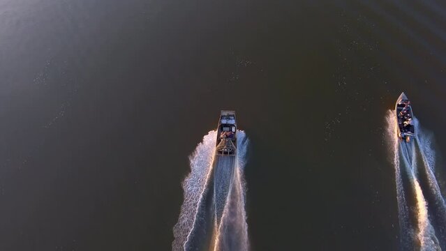 Aerial Forward Shot Of People Enjoying Driving Boats In River - Bayou, Louisiana