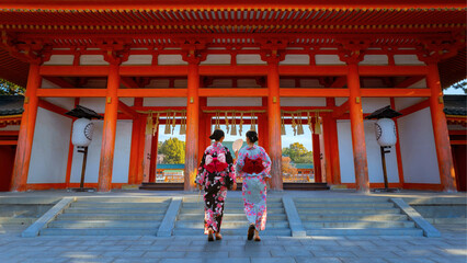 Young Japanese woman in traditional Yukata dress stroll in Heian Shrine in Kyoto, Japan