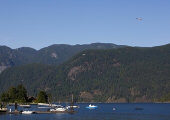 Fototapeta na wymiar Scenic view of a water bomber flying in the blue sky in Vancouver, British Columbia, Canada