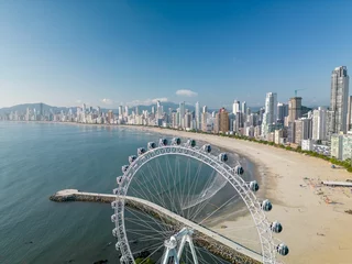 Poster Spectacular view of a huge paddle wheel on Balneario Camboriu city beach © Wirestock