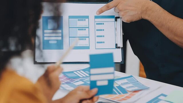 Team of Creative Web Graphic Designer planning, drawing website ux app for mobile phone application and development template layout, process to developing prototype wireframe, User experience concept.