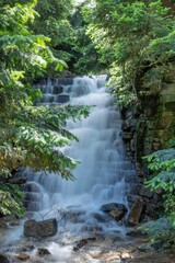 Vertical shot of a waterfall with long exposure in a jungle covered in greenery