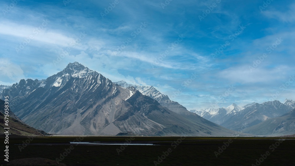 Canvas Prints Scenic view of an expansive countryside landscape with snowy mountain peaks