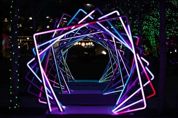 Dazzling neon display of rotating squares illuminates the night sky