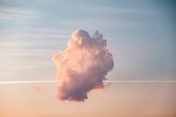Serene image of a majestic cloud formation against a vibrant sunset sky