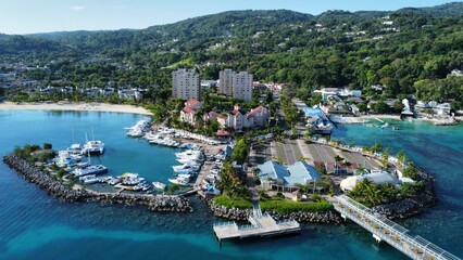 Aerial view of a tranquil bay with boats, surrounded by  variety of buildings: Ocho Rios, Jamaica