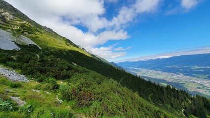 Scenic view of a green mountain range on a sunny day