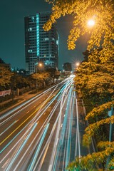 Long exposure shot of a city street at night with an illuminated roadway and scyscrapers in Vietnam