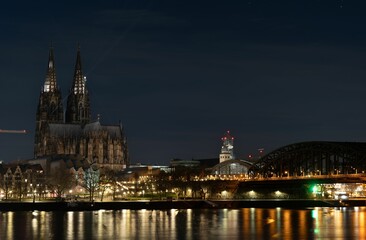 Cologne Cathedral at night with the city in the background in Cologne, Germany