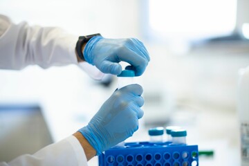 Chemist wearing protective gloves conducting a scientific experiment in a laboratory