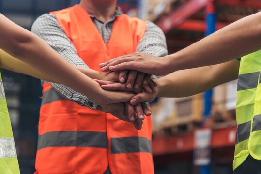 Diversity Teamwork hands stack together trust partner. Warehouse worker fist bump Engineer man, women hands holding partnership. Multiracial people fist bump partner colleague logistics Warehouse