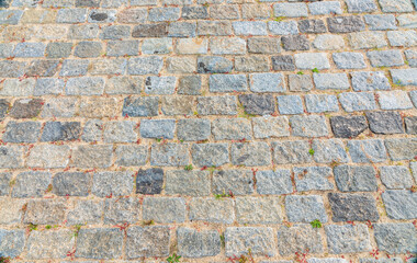 Naklejka premium Stone block pavement in the rays of the setting sun. Texture