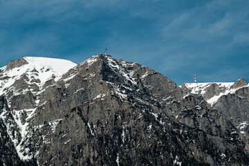 Scenic view of a cross on top of a snow-capped mountain