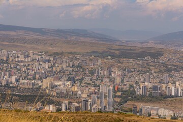 Aerial view of Vere in the Old Tbilisi District, with a cityscape and a vast field in the foreground