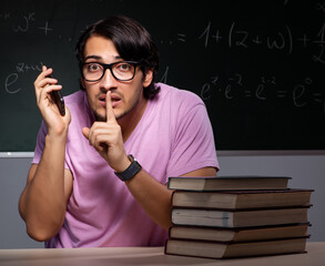 Young male student sitting in classroom