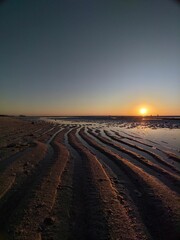 Stunning landscape of  a tranquil beachscape at sunset