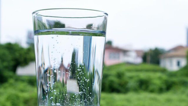 Dropping a tablet of antacid into a glass of water that burst into tiny bubbles in the water.
