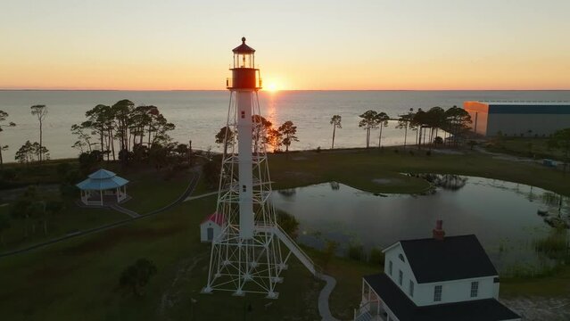 Drone shot of sunset and beautiful coastal views passing by the Cape San Blas Lighthouse in Port St. Joe, Florida