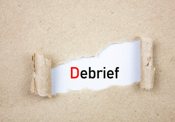 DEBRIEF acronym, inscription torn paper. Debrief concept.