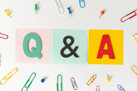 Top view of colorful post-it notes with top written with Q&A or questions and answers on white background.