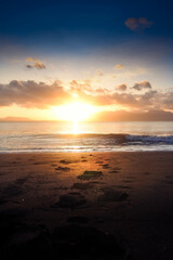 Beautiful golden sunrise, sands and blue sky on the beach.