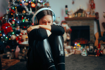Depressed Crying Woman Listening to Christmas Carols alone. Sad alone girl experience grief when...