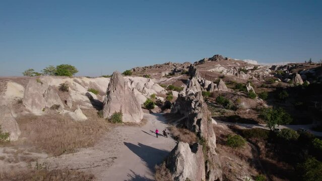 Aerial view of the rocks and hills of the unusual landscapes of Cappadocia. Drone video 4k