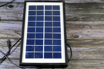 A solar panel, a device that converts sunlight into electricity by using photovoltaic (PV) cells which made of materials that generate electrons when exposed to light, to produce direct current DC - obrazy, fototapety, plakaty