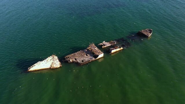 Aerial view around a shipwreck on the coast of sunny Rio del Mar, CA, USA