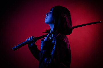 Silhouette in the dark, portrait of a young woman with a bob hairstyle in a black leather jacket with a katana in her hands, posing isolated on a dark background with red backlight, cyberpunk concept