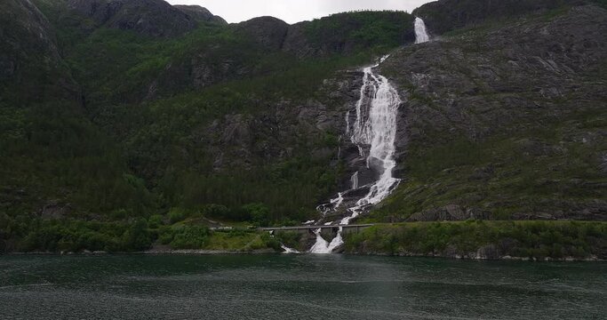 Motion and noise of white water cascading down mountainside, aerial