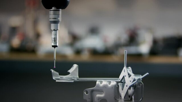 A precision CNC measuring machine testing a metal product if it is in the parameters of quality in the automated factory