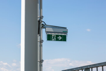Emergency exit indicator on a metal pillar