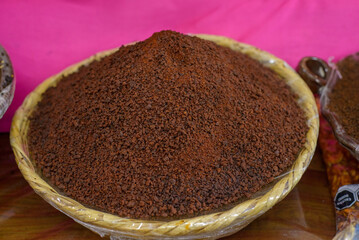 Container with mole powder. Typical Mexican food sold in a street market.