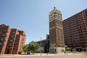 Afternoon sunlight shines on the historic buildings of the downtown skyline of Bartlesville,...