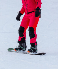 Naklejka premium A man snowboards in the snow in winter