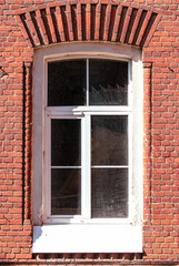 Stained glass window in an old brick house