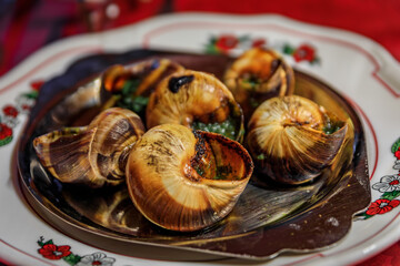 Traditional French escargot snails with butter, white wine and parsley served at an Alsatian...