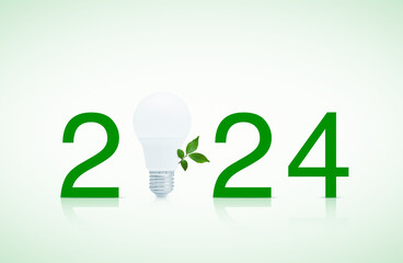 2024 text and LED light bulb with fresh green tree leaves on white background, Happy new year 2024...