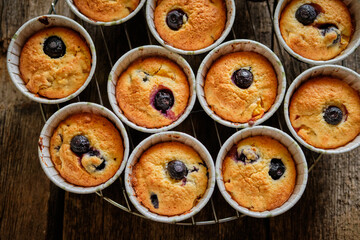 muffins with blueberries, on a wooden background, close-up.
