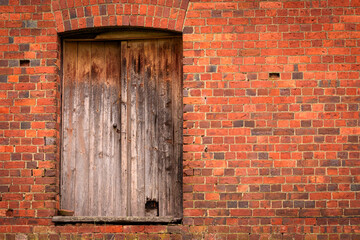 old red brick wall and wooden door 