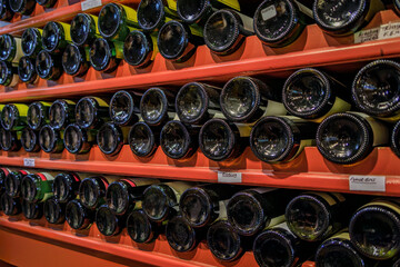 Bottles of traditional Alsatian white wine from local wineries lined up on store shelves in the...