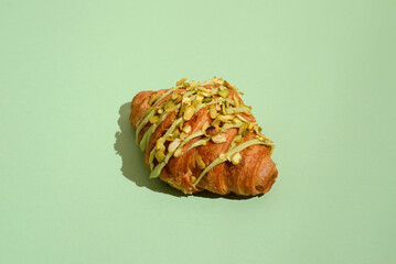 croissant with pistachio on a green background