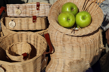 wicker baskets and green apples at the fair. translation of the inscription: "Made with love" - Powered by Adobe